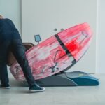 Person adjusting a massage chair in a clean, modern space.