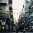 Colorful busy street scene in Cần Thơ, Vietnam with vibrant signs and people. — Providing Safe and Exciting Spaces for Childr