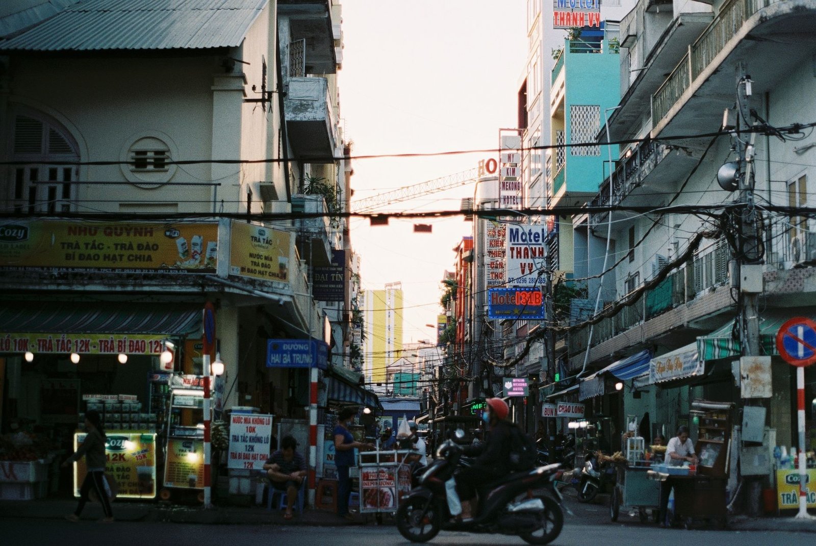 Colorful busy street scene in Cần Thơ, Vietnam with vibrant signs and people. — Providing Safe and Exciting Spaces for Childr