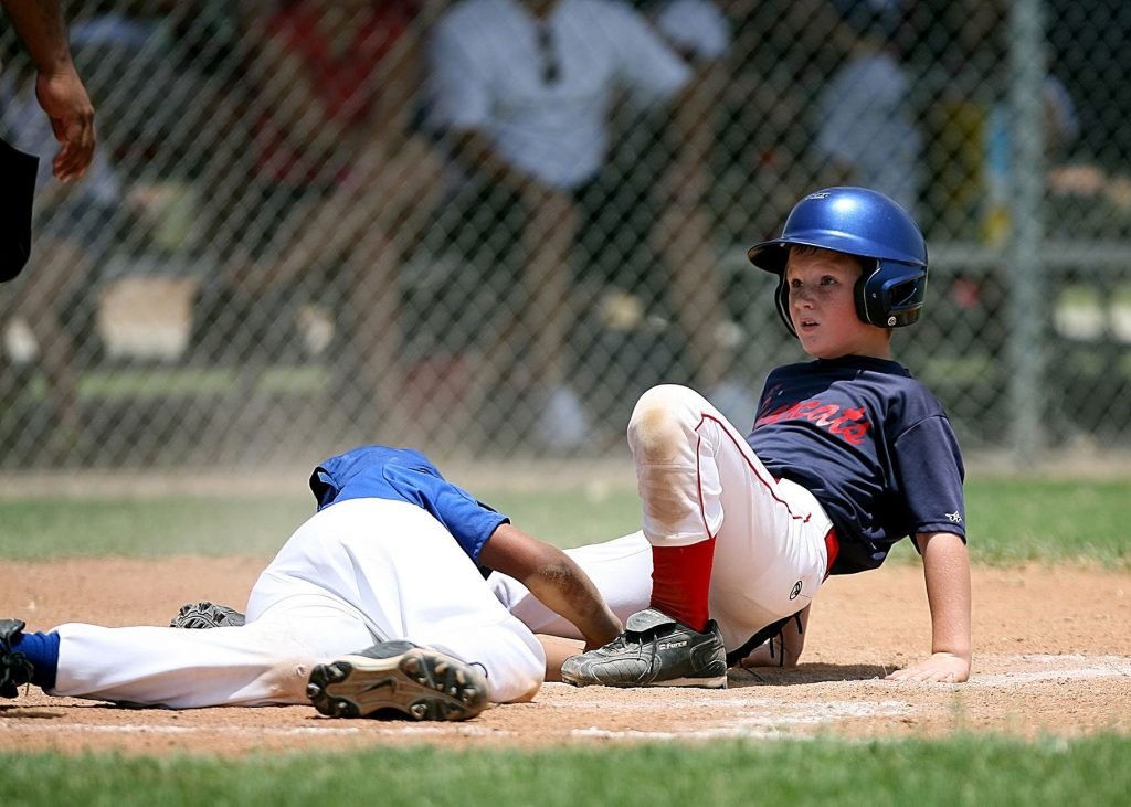 Young baseball players in action during an intense game at a sunlit field. — Streameast Soccer: The Go-To for Live Soccer Fan
