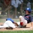 Young baseball players in action during an intense game at a sunlit field. — Streameast Soccer: The Go-To for Live Soccer Fan